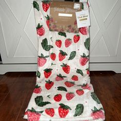 the seat cover is made out of fabric with strawberries and leaves printed on it