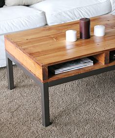 a coffee table with two candles on it