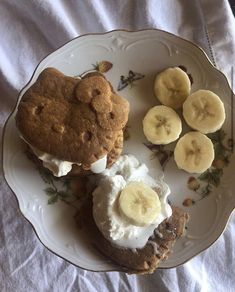 a white plate topped with cookies and banana slices