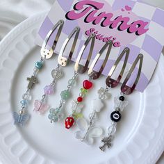 a white plate topped with lots of different types of hair clips