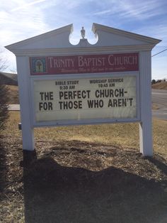 a sign that is in the grass by some dirt