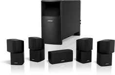 the home theater system is black and has five speakers, one speaker box and four subs