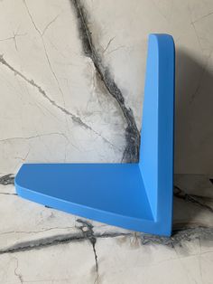 a blue shelf sitting on top of a marble floor