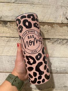 a hand holding a pink and black leopard print tumbler