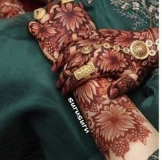 a woman's hand with henna on it