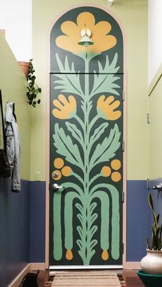 the door is decorated with flowers and leaves in green, blue, and yellow colors