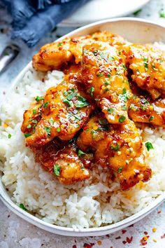 a white bowl filled with chicken and rice