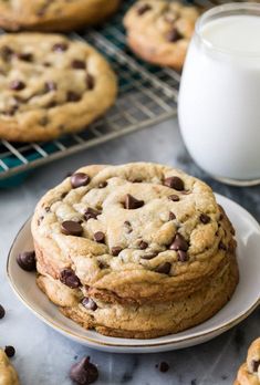 chocolate chip cookies on a plate next to a glass of milk