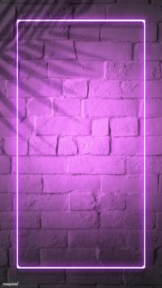 a purple neon frame on a brick wall