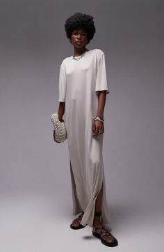 Made from supple jersey, this flowy maxi dress is simply styled so you can show off your accessories or keep it minimalist. Crewneck Elbow-length sleeves Side-seam pockets Side slits 100% polyester Machine wash, line dry Imported T Shirt Dress Maxi, Beige Maxi Dress With Side Slits, Chic Beige Maxi Dress With Side Slits, Elegant Beige Relaxed Fit Maxi Dress, Casual Beige Maxi Dress For Evening, Beige Relaxed Fit Maxi Dress, Spring Neutral Maxi Dress, Elegant Oversized Short Sleeve Maxi Dress, Minimalist Crewneck