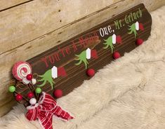 a wooden sign with candy canes on it