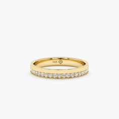 a yellow gold band with white diamonds