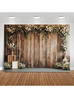 a wooden wall with flowers on it and a white lantern in the corner next to it