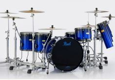 a blue drum set sitting on top of a white floor