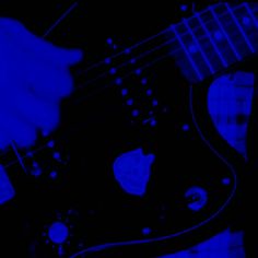 a person playing an electric guitar with blue light in the dark night sky behind them