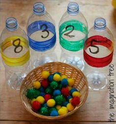 plastic bottles with numbers and balls in them on a wooden table next to water bottles