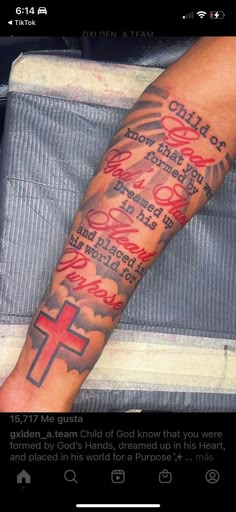 a person with a cross tattoo on their arm