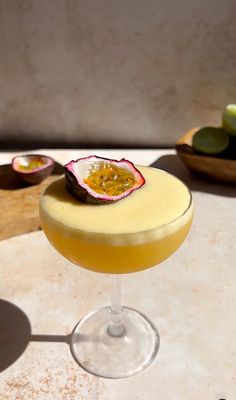 a drink with fruit on the rim sitting on a table