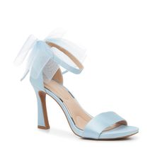 a women's blue high heeled sandal with a bow on the ankle