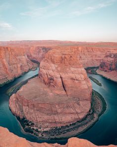 a river flowing through a canyon surrounded by mountains