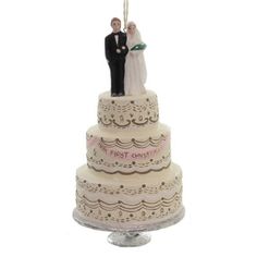 a wedding cake with a bride and groom figurine hanging from it's side