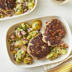 two plates filled with meat and potatoes on top of a table