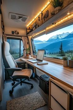 the interior of an rv with a desk, chair and laptop on it's side