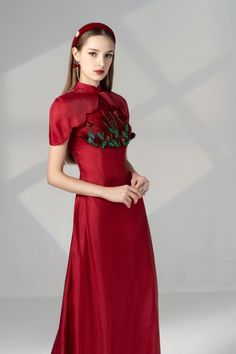 Indulge in luxury with our Ao Dai. Made with the finest silk organza, this sheath design features delicate flower appliques that flow down the full length of the garment, creating a stunning and elegant look. Elevate your style with this exclusive piece. Length: Top: 150cm, Pants: 110cm Floor-length Satin Dresses For Ceremony, Fitted Organza Gown With Floral Embroidery, Fitted Floral Embroidered Organza Gown, Floral Embroidered Organza Gown For Banquet, Fitted Red Silk Gown, Elegant Floor-length Evening Dress For Ceremony, Organza Gown With Floral Embroidery For Banquet, Elegant Long Dress With Floral Embroidery, Fitted Silk Gown With Floral Embroidery