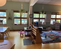 an empty classroom with lots of windows and furniture