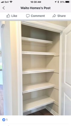 an empty closet with white shelves in it