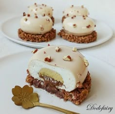 three desserts on white plates with a gold spoon and flower in the foreground