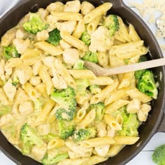 a skillet filled with pasta and broccoli on top of a white table