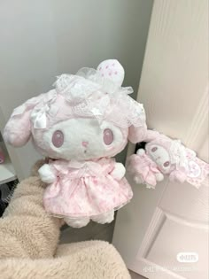 a stuffed animal is wearing a pink dress