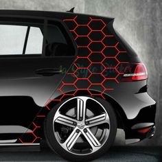 the side view of a black car with red honeycombs on it's sides