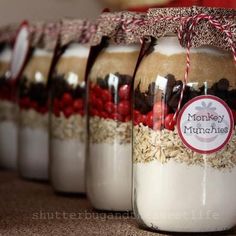 jars filled with cookies and milk sitting on top of a brown tablecloth covered floor