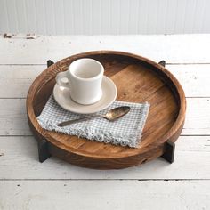 a wooden tray with a cup and saucer on it