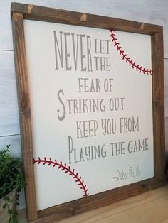 a wooden frame with a baseball saying on it