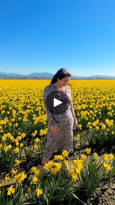 a woman standing in a field full of yellow flowers