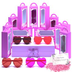 the pink and purple boxes are filled with heart - shaped sunglasses, one is for barbie