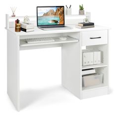 a white desk with a computer on top of it and some books in front of it