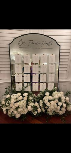 flowers are arranged in front of a mirror for a wedding ceremony at the grand florist