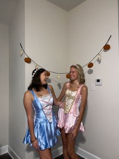 two women dressed in costumes standing next to each other