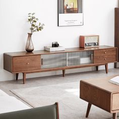 a living room with a couch, coffee table and television on top of the entertainment center