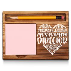 a wooden frame with a notepad, pencil and eraser on it in the shape of a heart