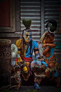 two people with painted faces sitting next to each other