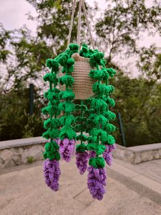 a purple and green decoration hanging from a rope