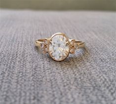 a close up of a ring with a diamond on it's side, sitting on the ground