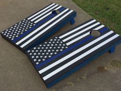 an american flag cornhole game set with blue and white stripes on the back ground