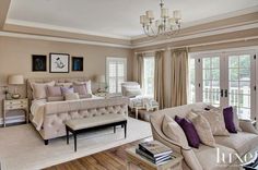 a living room filled with furniture and a chandelier