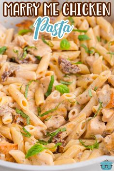 a pasta dish with chicken and parsley in a white bowl